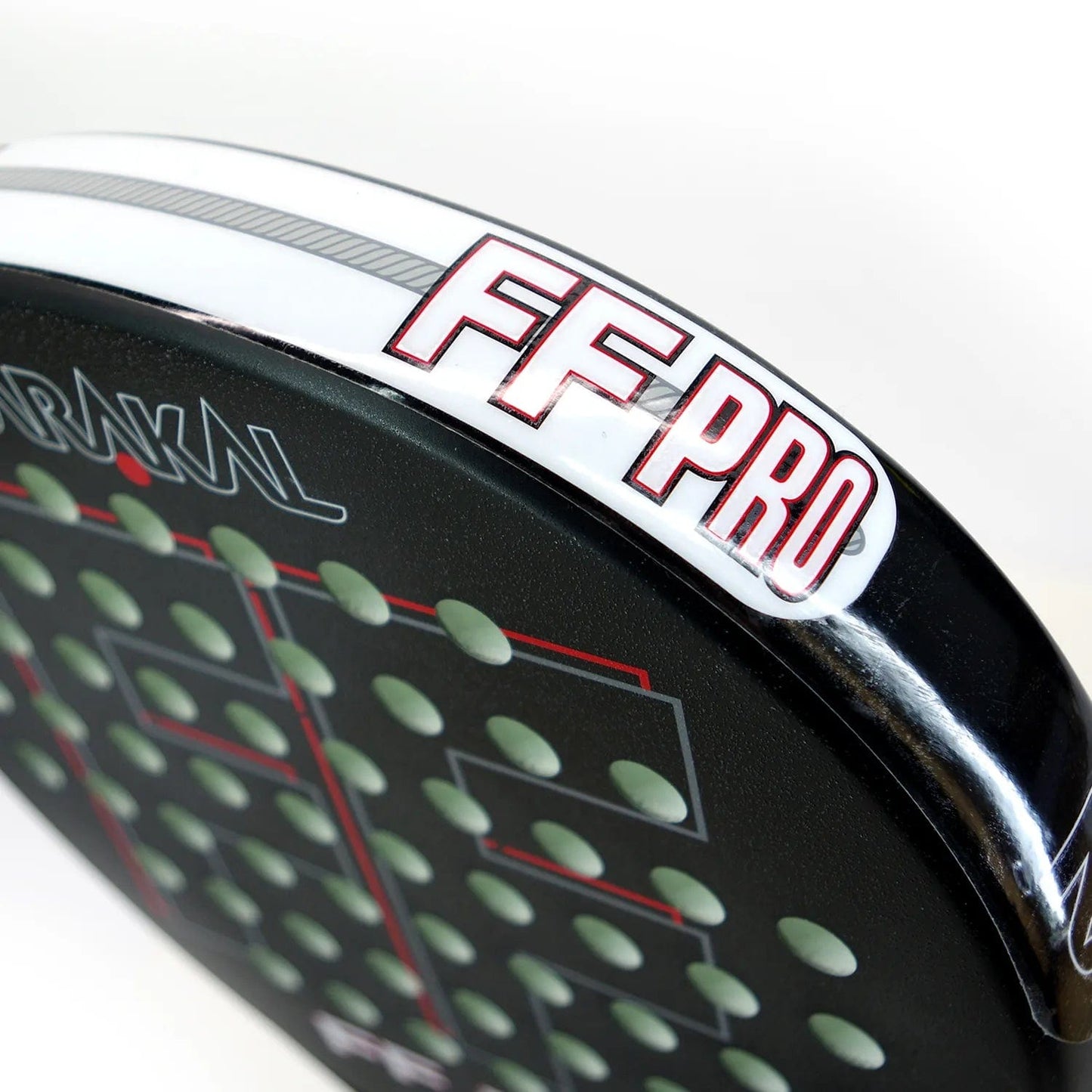 Close-up of the Karakal FF Pro 375 Padel Racket - Black, highlighted by red and white branding around the edge. The racket's surface is perforated with small holes arranged symmetrically to improve spin shots.