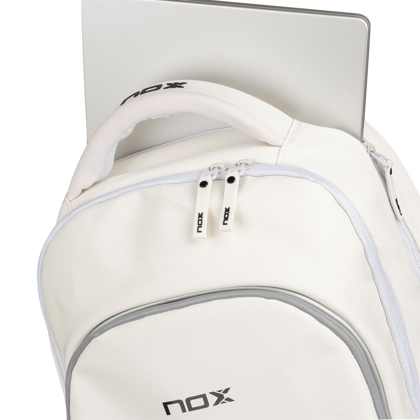 The NOX Pro Series Padel Backpack - White by NOX features gray accents and a partially unzipped main compartment showing a silver laptop inside. The NOX logo is visible, making it perfect for carrying your padel essentials.