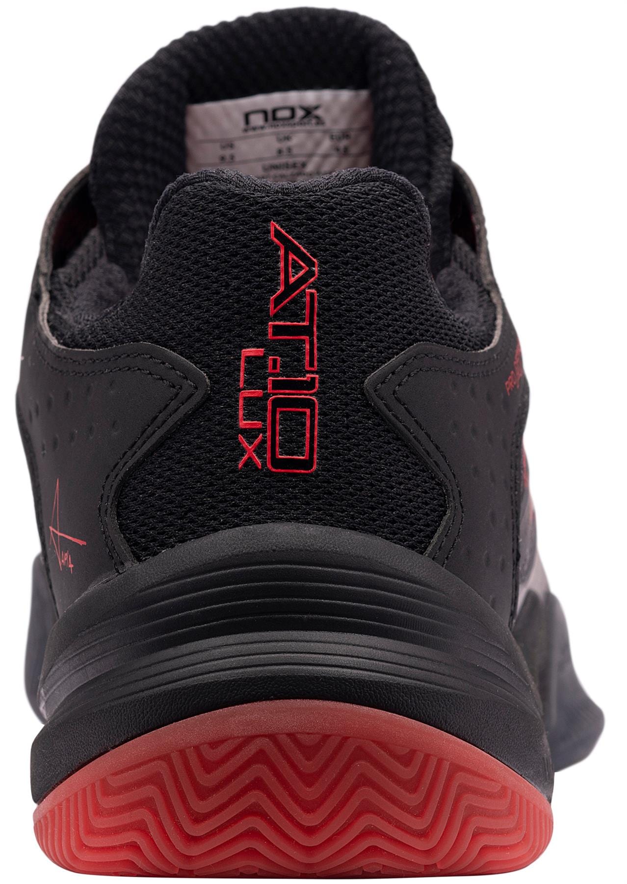 A close-up rear view of the NOX AT10 Lux Men's Padel Shoes in black and red, featuring "AT10 LUX" and "NOX" on the heel. This model offers Ortholite comfort, a black sole, and bold red tread.