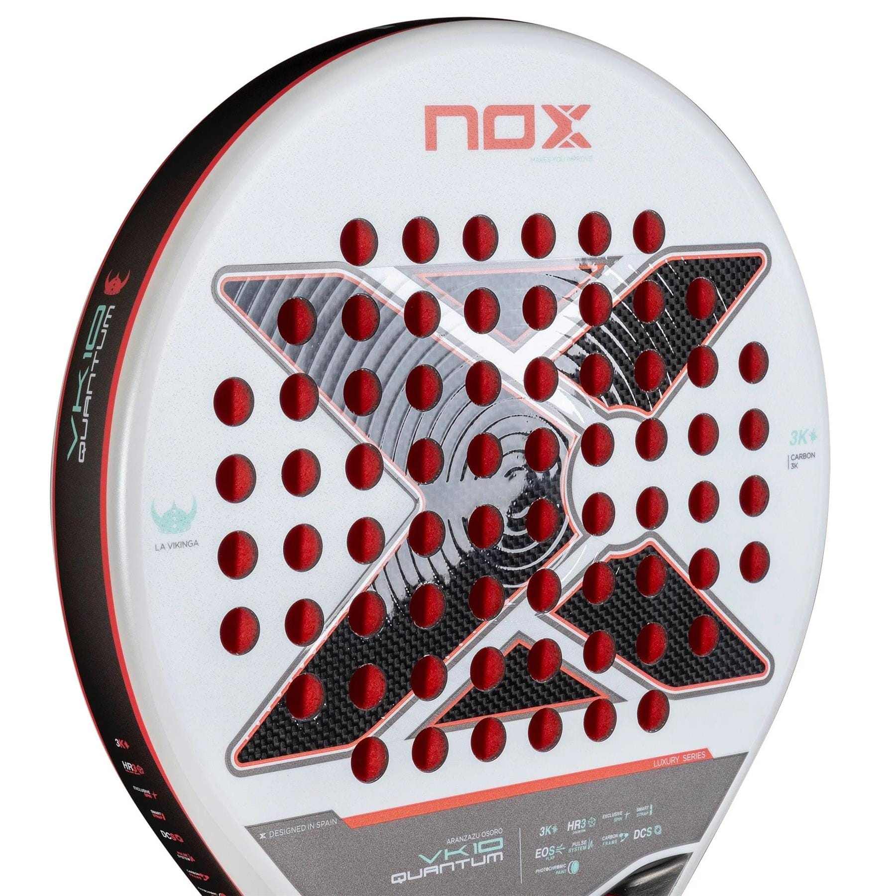Close-up of the NOX Luxury VK10 Quantum 3K By Aranzazu Osoro 2025 padel racket in white, with red and black accents, a large black "X" Quantum 3K design at the center, and circular red holes across the face.