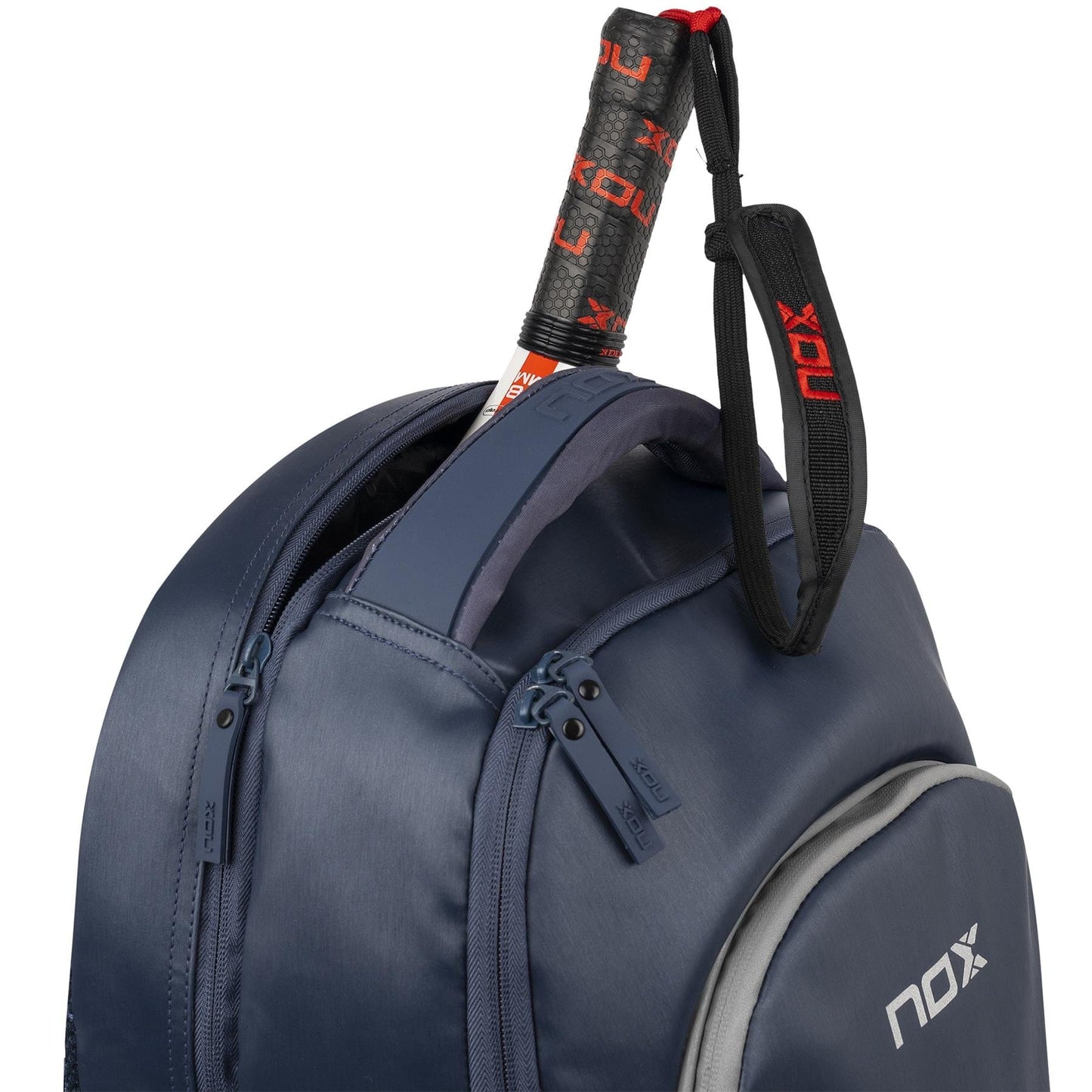A NOX Pro Series Padel Backpack - Blue holds a padel racket with a black and red NOX grip visible at the top, showing the brand’s distinct design.