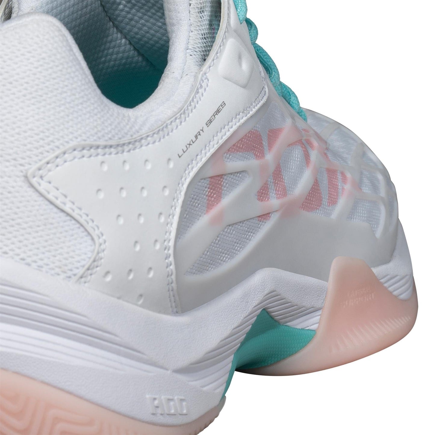 Close-up of the NOX AT10 Lux Womens Padel Shoes in White/Potpurri, featuring teal laces, pink accents, mesh details, "LUXURY SERIES" near the heel, and layered textures for top padel performance from brand NOX.