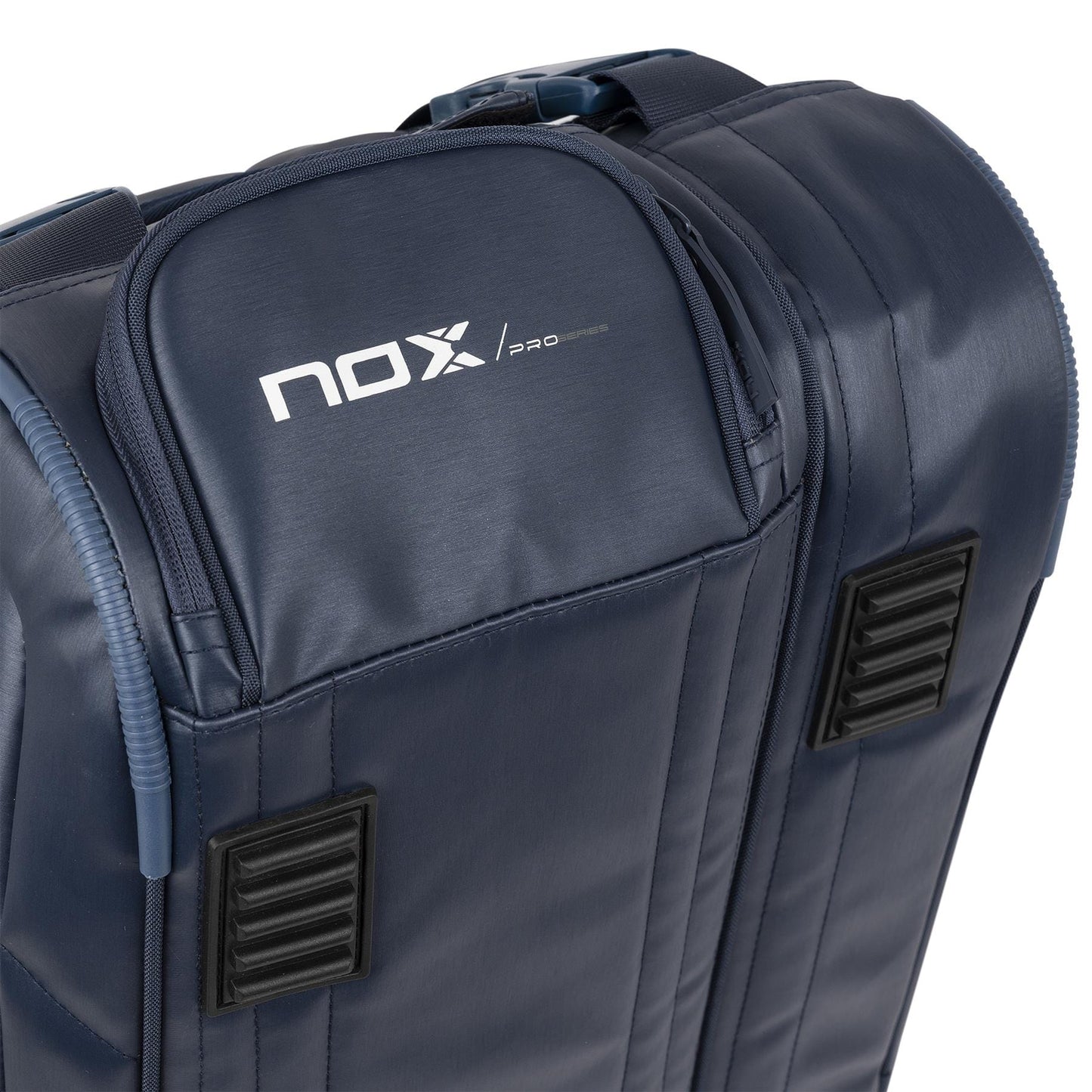 Close-up of the NOX Pro Series Padel Racket Bag - Blue, featuring a sturdy top handle, zippers, dual rectangular ventilation panels, and the NOX logo on the upper pocket. ThermoTech technology protects your gear.
