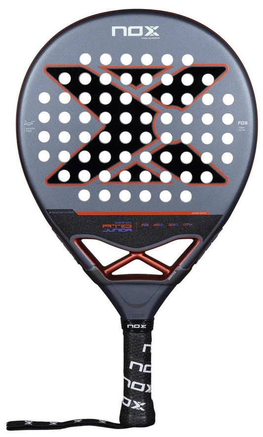 The NOX AT10 Genius Junior By Augustin Tapia 2025 Padel Racket features a carbon frame, black and gray design with a bold "X," circular holes, a black handle with the NOX logo, and wrist strap—ideal for young players' development.