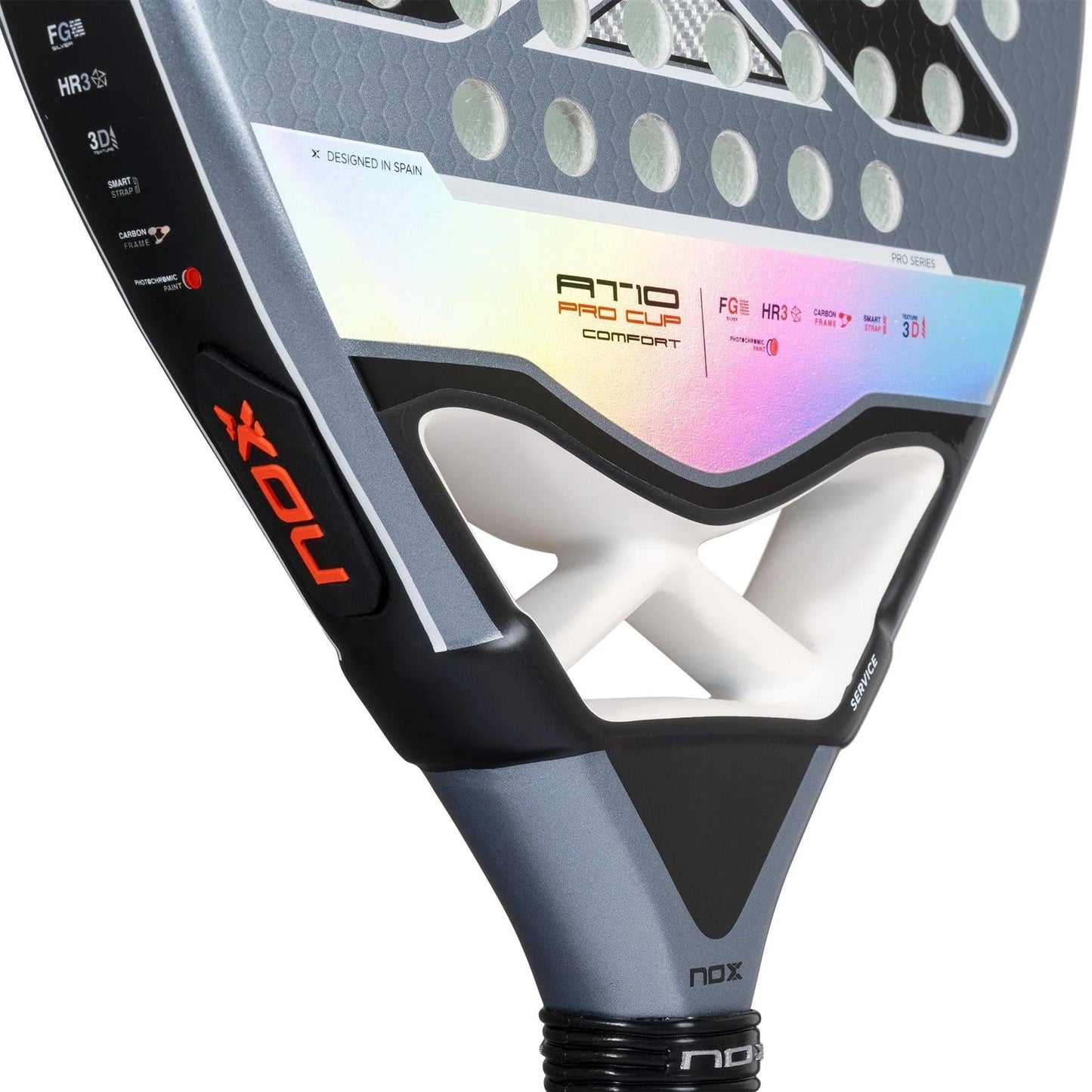 Close-up of the NOX AT10 Pro Cup Comfort By Agustin Tapia 2025 padel racket, showing the handle with Smartstrap tech, throat design, and part of the face with branding and specs in white, black, and iridescent accents.