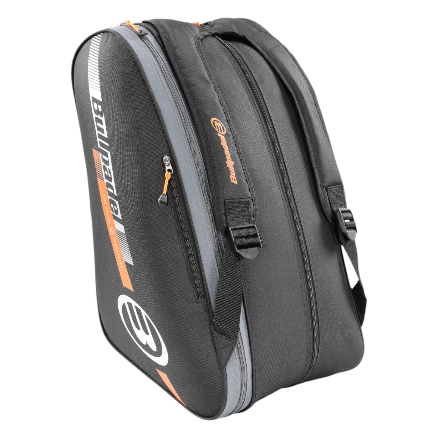 The Bullpadel Tour 25 Padel Racket Bag in black, accented with orange and featuring a white logo, offers zippered compartments for organization. With a sleek design, two front adjustable straps, and a padded racket compartment, it is ideal for those needing a spacious bag.