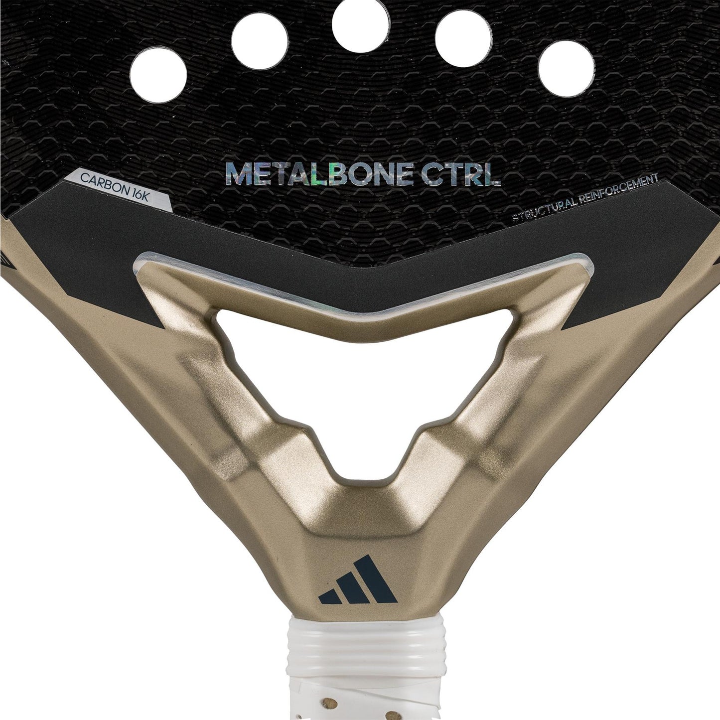 A close-up of the adidas Metalbone CTRL 3.4 Padel Racket - Gold displays its black surface with circular cutouts and metallic gold accents, highlighting "METALBONE CTRL 3.4" and "CARBON 16K" text. The octagonal structure enhances stability, with the adidas logo prominently visible at the bottom.