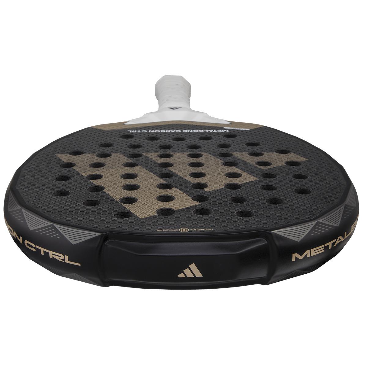 Close-up of a black ADIDAS Metalbone Carbon CTRL 3.4 Padel Racket with a gold "W" logo and multiple holes. The handle is white, and "Metalbone Carbon CTRL" suggests performance and precision for advanced players.