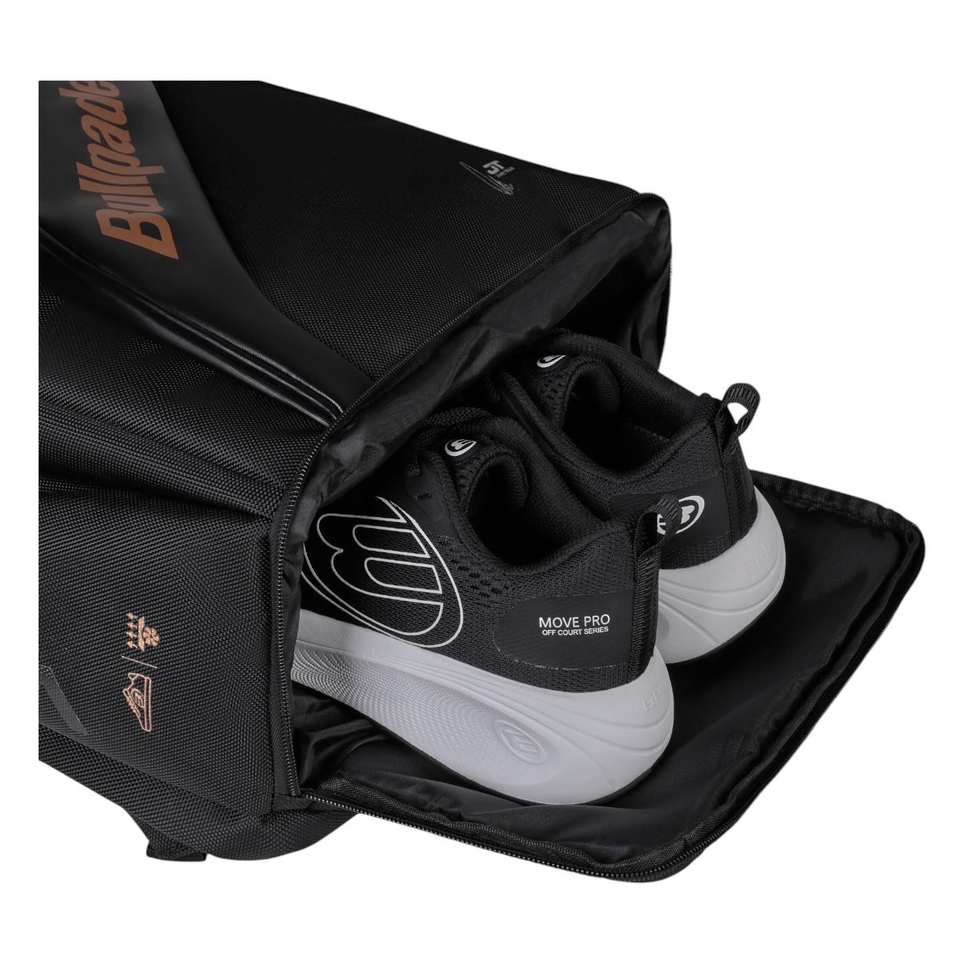 The Bullpadel Vertex 25 Padel Backpack in black, with its open compartment revealing a pair of MOVE PRO sneakers, is perfect for carrying your padel racket. The bag features the "Bullpadel" text in orange while the sneakers display the "MOVE PRO" label on their sides.