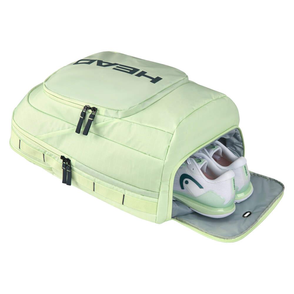 The HEAD Pro 30L Padel Backpack - LLAN is a versatile sports bag in light green, constructed from durable ripstop fabric, featuring the "HEAD" logo prominently on the top. It includes multiple compartments, along with a partially open shoe section that displays white and green sports shoes inside.