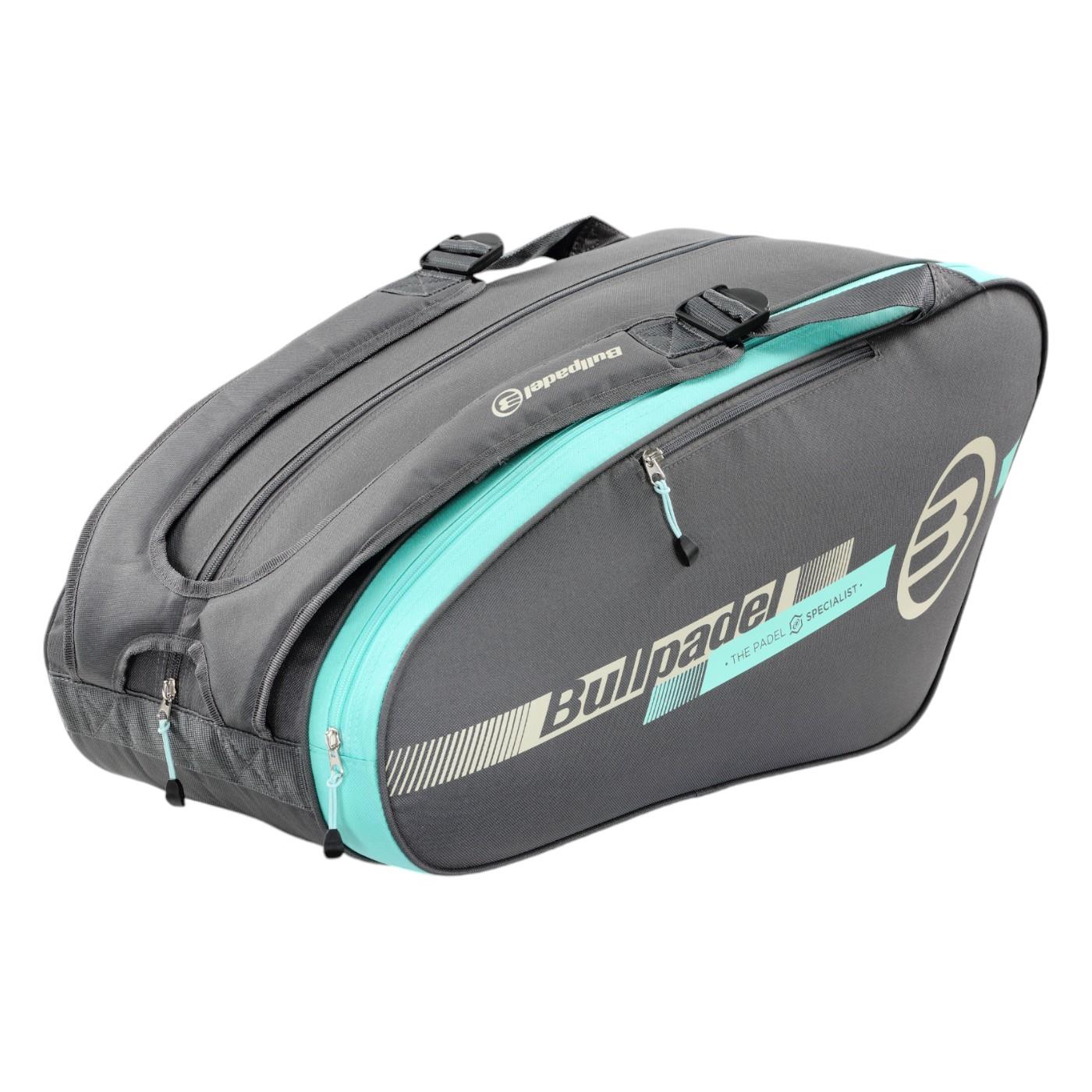 The Bullpadel Tour 25 Padel Racket Bag - Grey features the iconic Bullpadel branding, a padded racket compartment, multiple zippered sections, and convenient shoulder straps for easy carrying.
