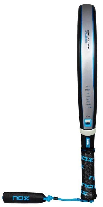 The NOX Luxury Quantum 12K Cobalt 2025 Padel Racket by NOX features a black handle with blue and black grip tape, a blue wrist strap, and a gray-blue face made from durable 12K carbon fibre.