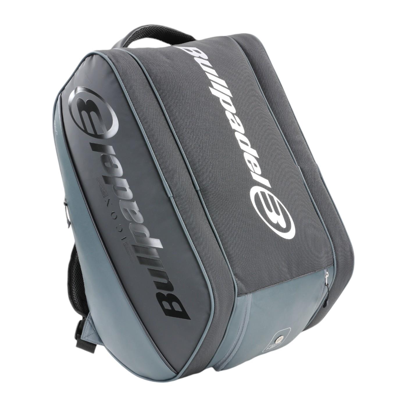 Introducing the Bullpadel Icon 25 Padel Racket Bag - Graffiti: a grey and black bag with a spacious compartment and padded straps. Featuring the Bullpadel logo in white, it's perfect for fans of legends like Juan Martín Díaz on the court.