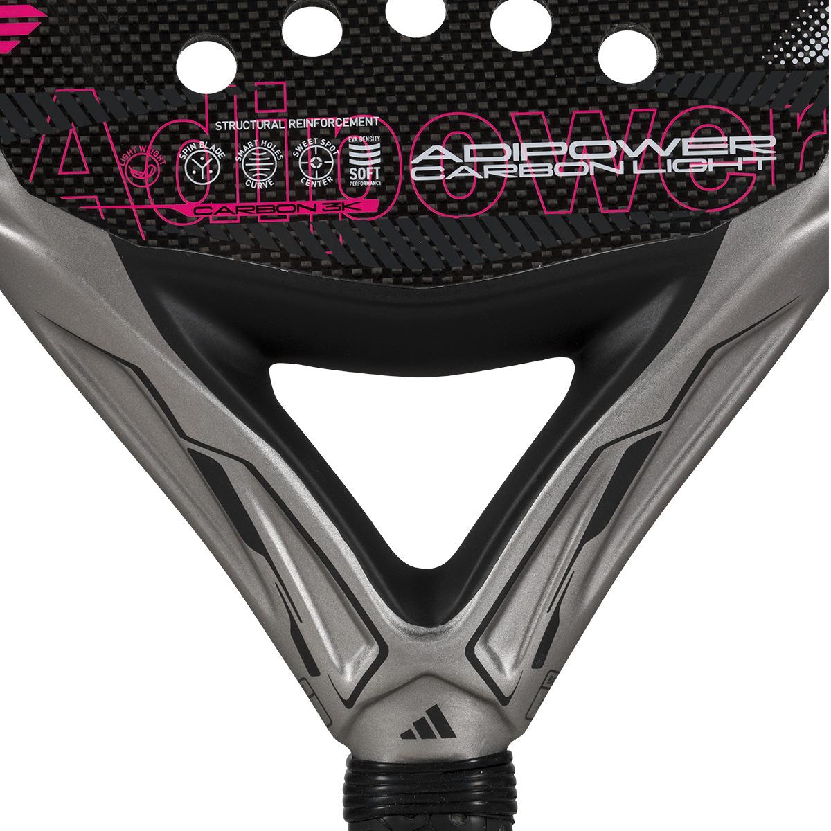 The ADIDAS Adipower Carbon Light 3.4 Padel Racket in silver and pink features a sleek design with Carbon 3K Fibre texture. "Adipower" branding stands out in bold pink, highlighting structural reinforcement, a 3D Spin Blade Mold, and a gracefully positioned handle at the bottom.