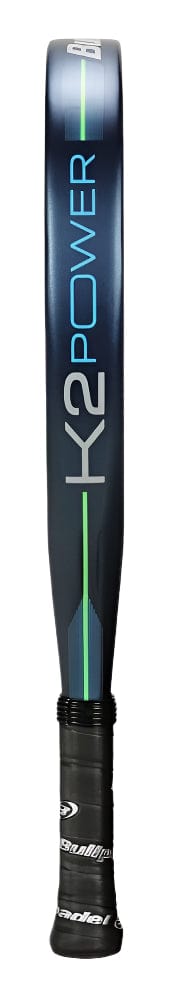 A side view of the Bullpadel K2 Power 2025 Padel Racket, featuring a sleek design similar to a tennis racquet, with a black handle, dark frame inscribed in blue and white letters, and a thin green line running lengthwise.