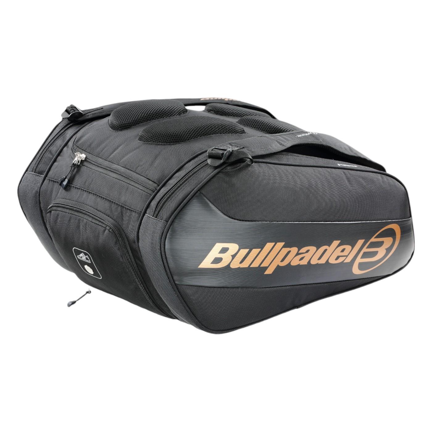 The Bullpadel Vertex 25 Padel Racket Bag in black features zippered compartments, a ventilated section, and a gold logo. It has top handles and ample space for gear like the Vertex Padel Racket.