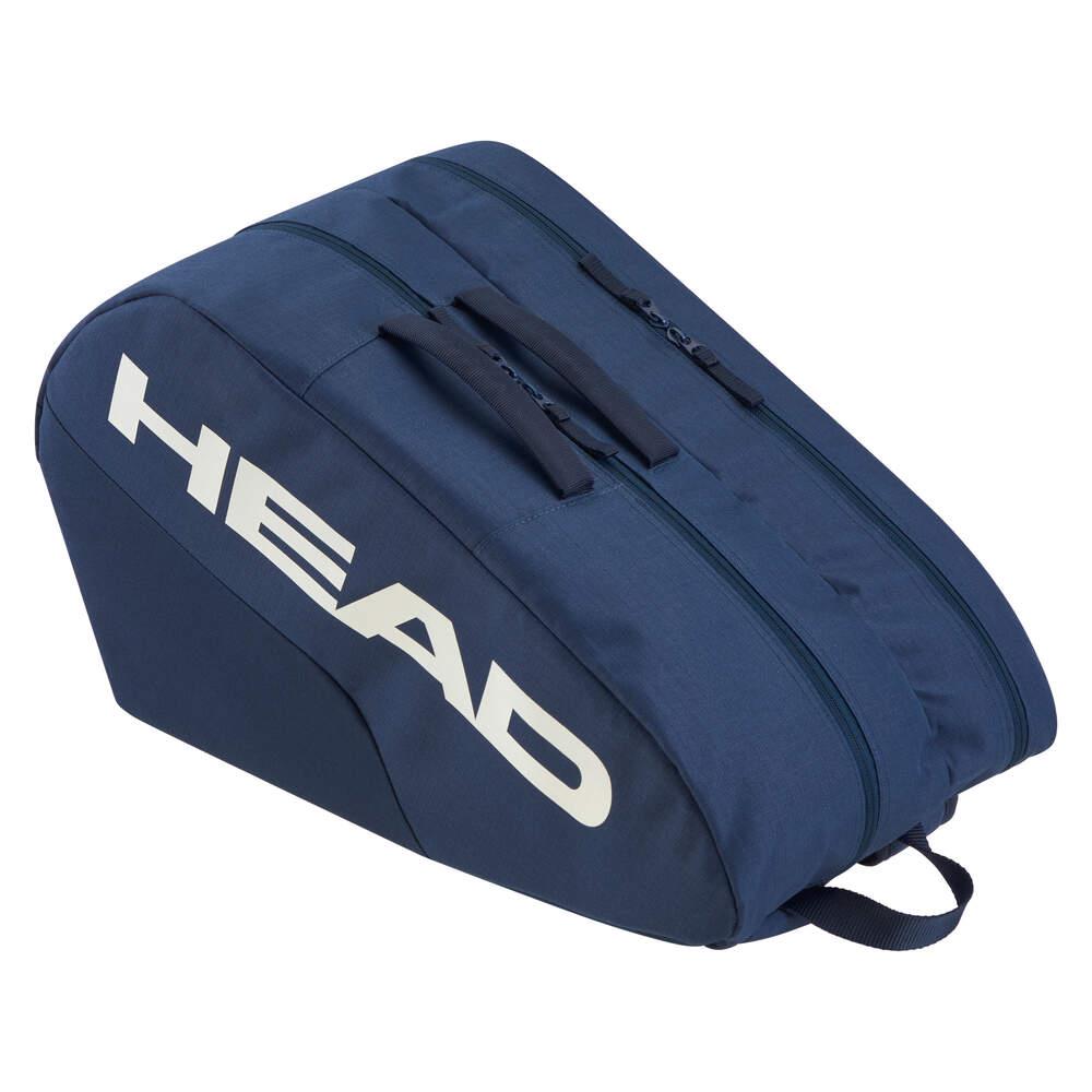 The HEAD Base Padel Racket Bag M in navy includes dual top zippers, accessory pockets, and a side handle. It has reinforced construction for durability with "HEAD" printed in large white letters on the side.