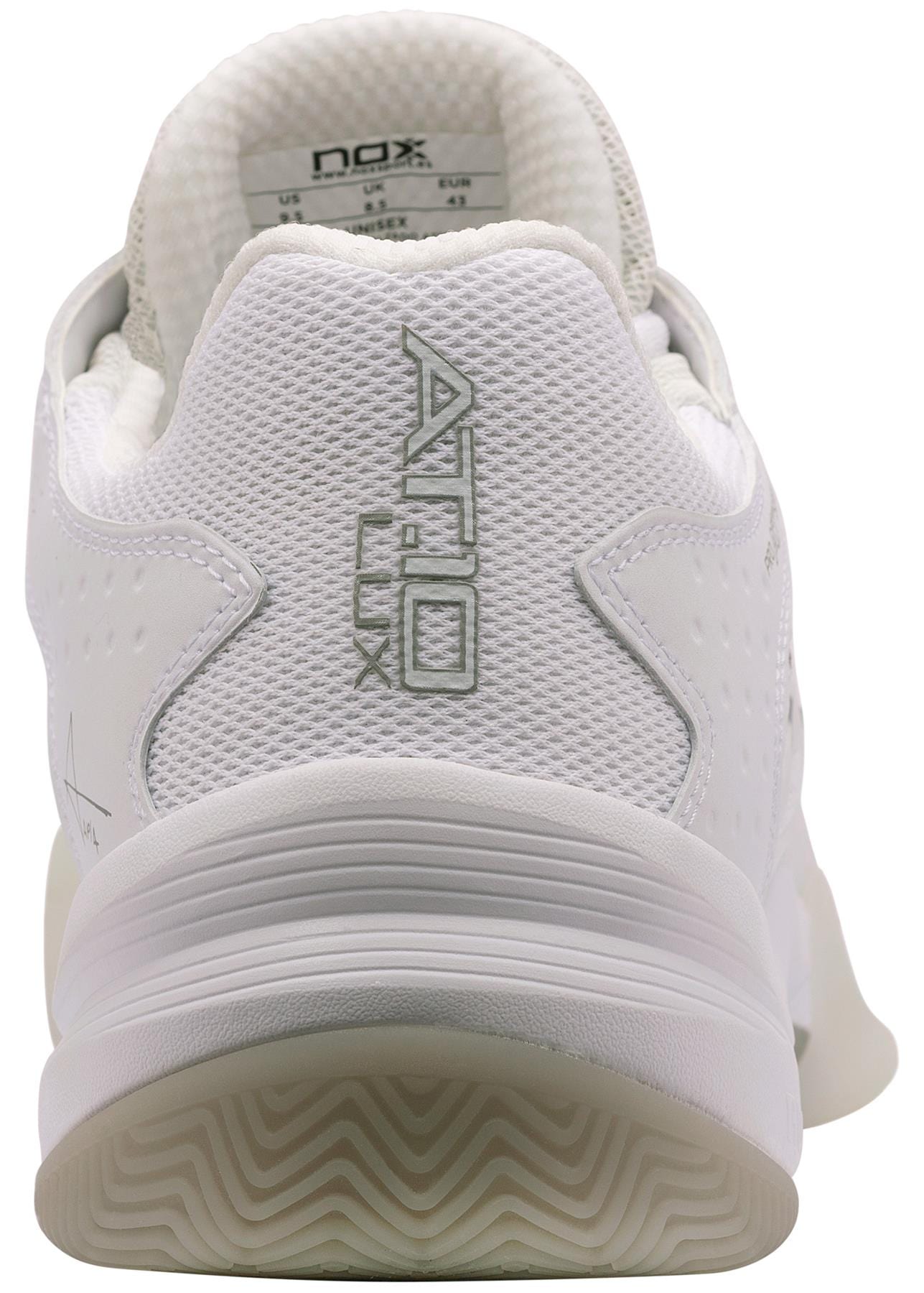 A close-up rear view of the NOX AT10 Lux Mens Padel Shoes - White / Grey, featuring "AT10 LUX" embroidered in gray on the heel, a textured midsole, and a white patterned sole. Brand: NOX.