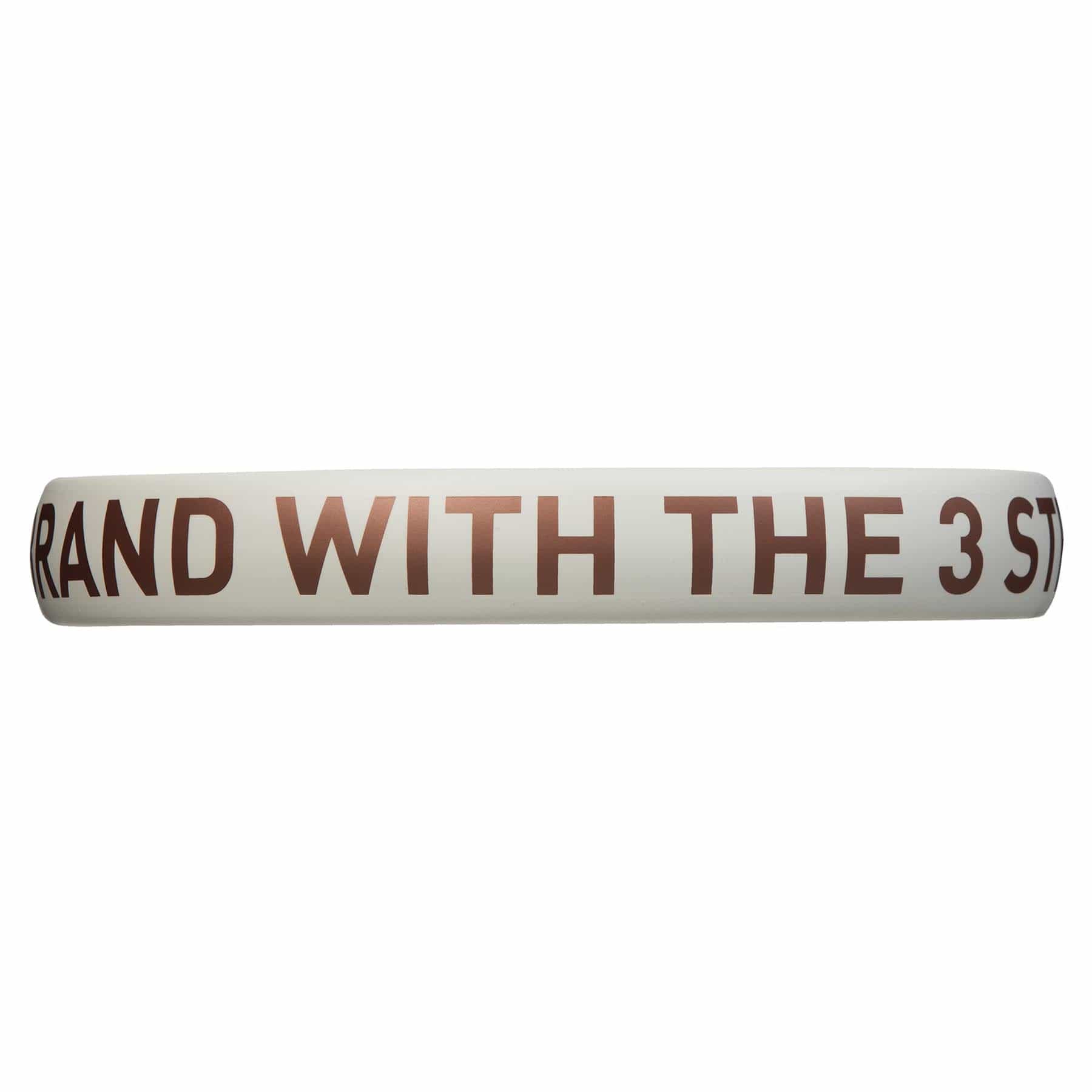 A white circular object, possibly a ring or band, displays brown text that partially reads "RAND WITH THE 3 ST." It resembles the balance and precision found in an ADIDAS Drive 3.3 Padel Racket - Vintage by adidas, renowned for its control and comfort—ideal for beginners seeking to refine their skills.