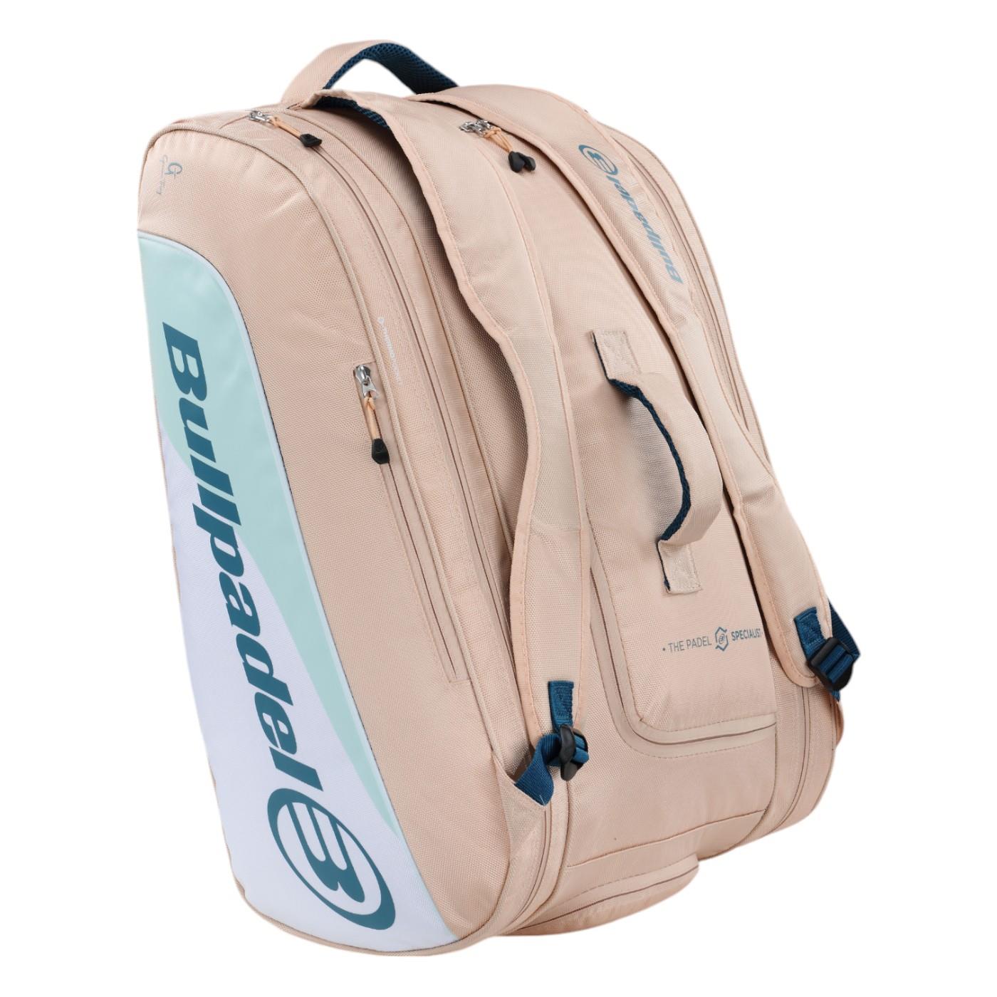 A pink Bullpadel Elite 25 padel racket bag featuring thermo-lined compartments and adjustable straps. This sleek bag, displaying the brand's logo, is designed for gear transport with a style inspired by Gemma Triay.