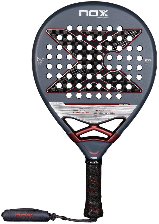 The NOX AT10 Luxury Genius 12K By Agustin Tapia 2025 Padel Racket features a teardrop shape, gray and black design with a bold "X", durable 12K carbon fibre, Exclusive Spin tech, and comes with a black grip and wrist strap.