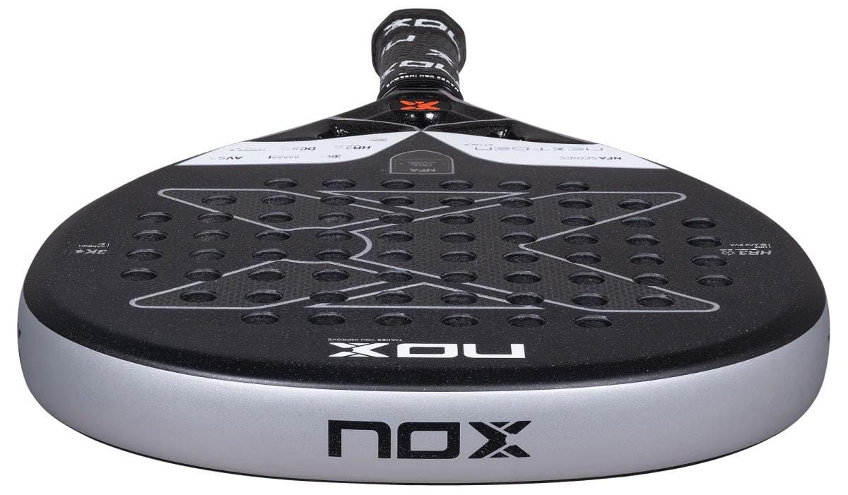 Close-up of the NOX NFA Nextgen Pro Attack 3K Padel Racket in black and silver, featuring a perforated face for precision and the NOX logo on both the handle and surface.