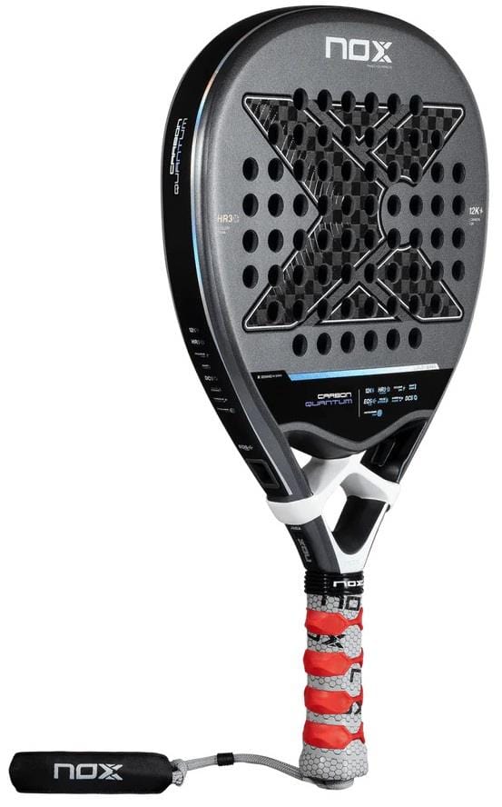 The NOX Luxury Quantum 12K Carbon 2025 padel racket in black/grey features a bold "X" design, perforated holes, a white-red grip with wrist strap, and showcases the NOX brand's premium CARBON 12k construction.