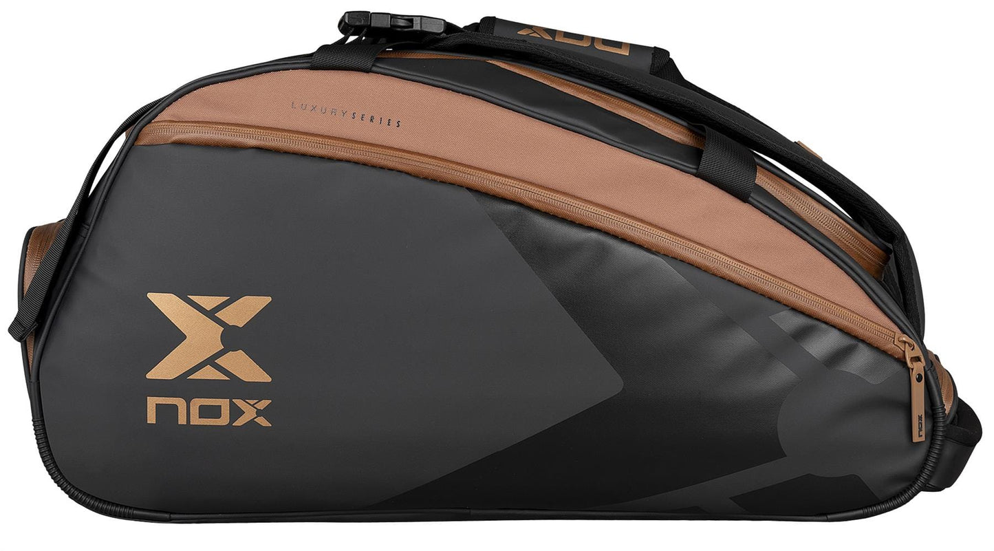 The NOX Luxury Open Series Padel Racket Bag in black and brown features gold "Nox" and "Luxury Series" lettering, multiple handles and zippers, plus a spacious thermal compartment with NOX ThermoTech technology.