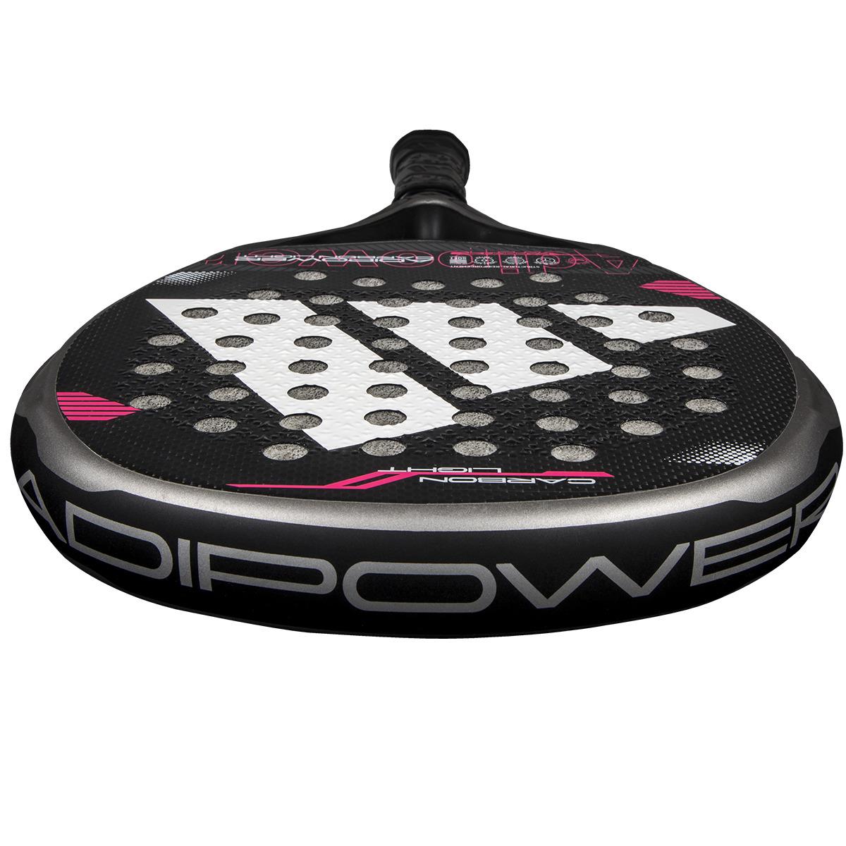 Close-up view of the adidas Adipower Carbon Light 3.4 Padel Racket in silver and pink, featuring "ADIPOWER" on the side, enhanced by Carbon 3K Fibre and 3D Spin Blade Mold, with circular holes throughout.
