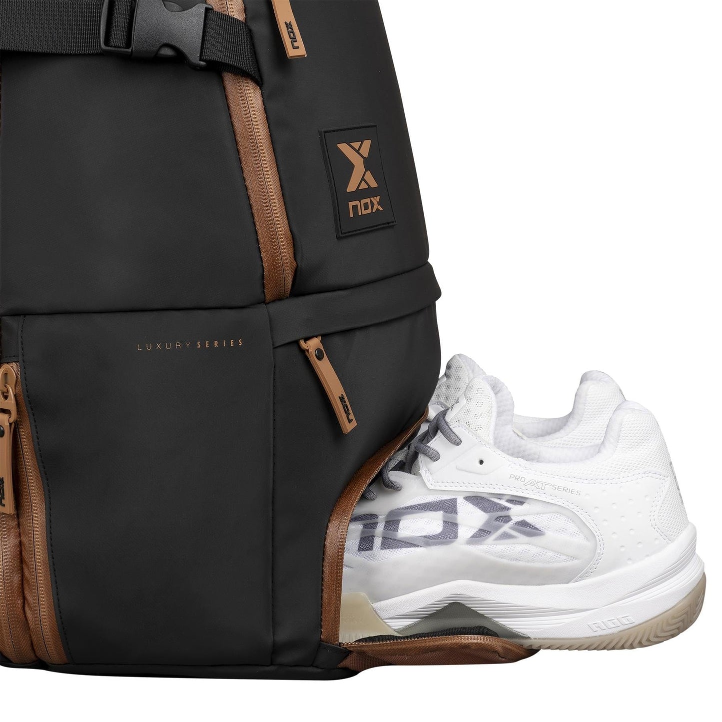 A white athletic shoe is partially placed in the side zippered compartment of the NOX Luxury Open Series Padel Backpack - Black / Brown, featuring an air ventilation system and "Luxury Series" labeling for freshness.