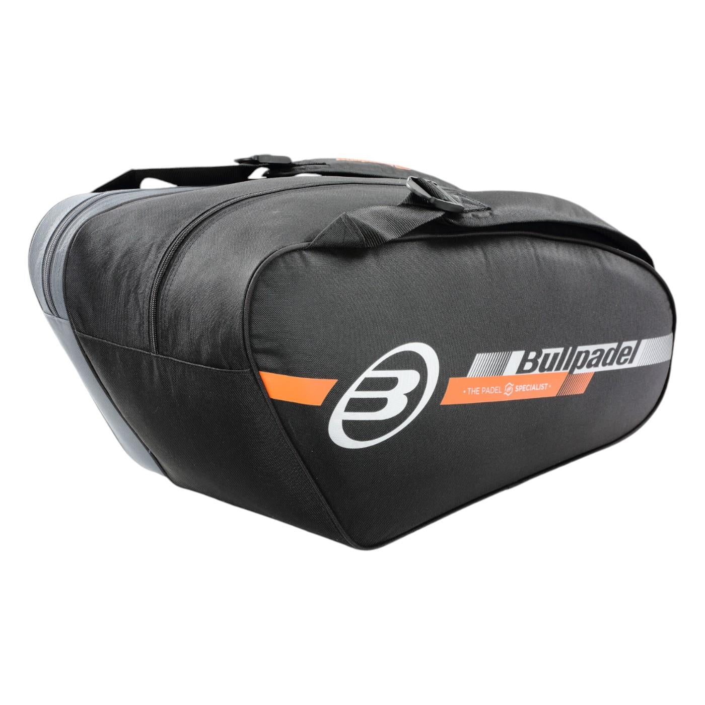The Bullpadel Tour 25 Padel Racket Bag in black offers a spacious central area, padded racket compartment, and a comfy shoulder strap. Orange accents enhance the sleek look, with the Bullpadel logo and brand name prominently featured on the side.