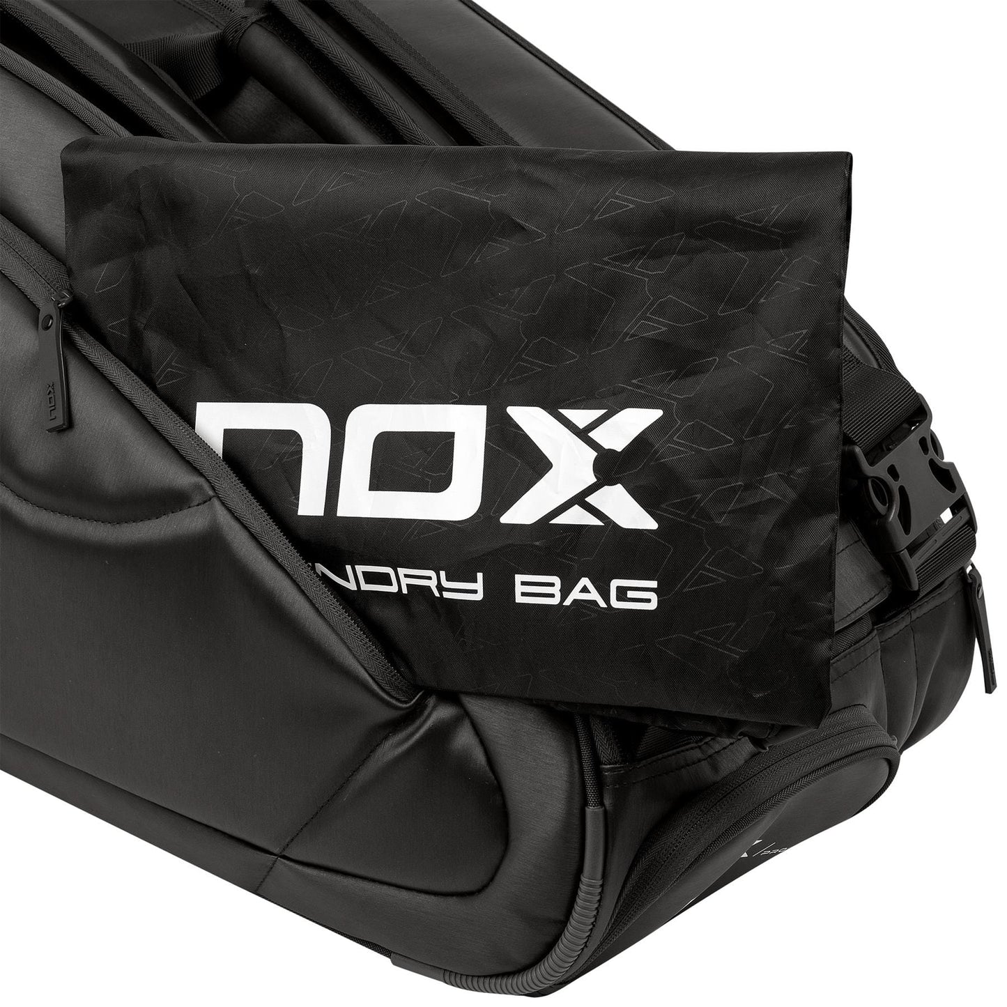 A black NOX laundry bag with bold white branding is partially tucked into the side pocket of the NOX Pro Series Padel Racket Bag - Black, complementing its ergonomic main handle for convenient transport.