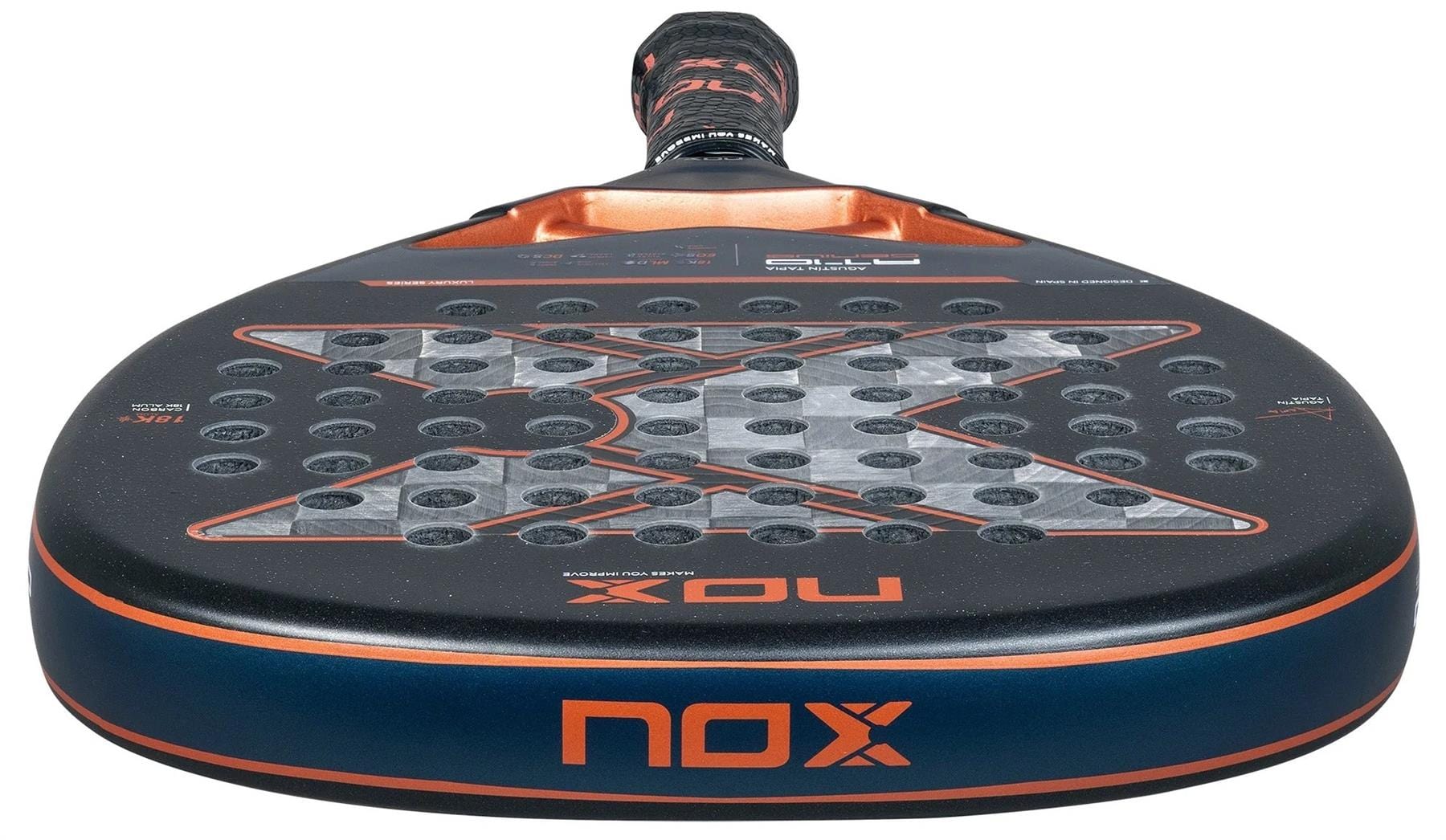 Close-up of the NOX AT10 Luxury Genius Attack 18K Alum By Agustin Tapia 2025 padel racket, featuring a striking black and orange design, perforated face, and the prominent NOX logo on the head.