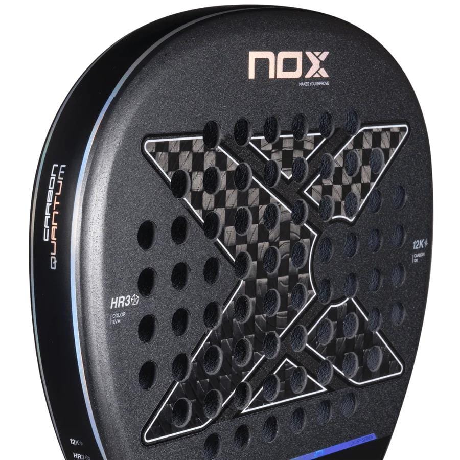 Close-up of the NOX Luxury Quantum 12K Carbon 2025 Padel Racket in black/grey, showing its large textured X design, circular holes, and details like "Luxury Quantum CARBON 12k" and "HR3" on the side.