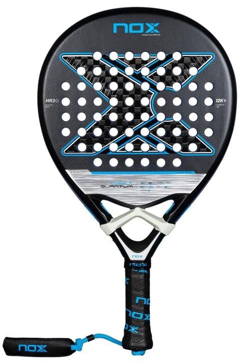 The NOX Luxury Quantum 12K Cobalt 2025 Padel Racket in black/blue features a round head, 12K carbon fibre, perforated holes, an "X" center design, black grip tape with blue NOX branding, and a safety strap.