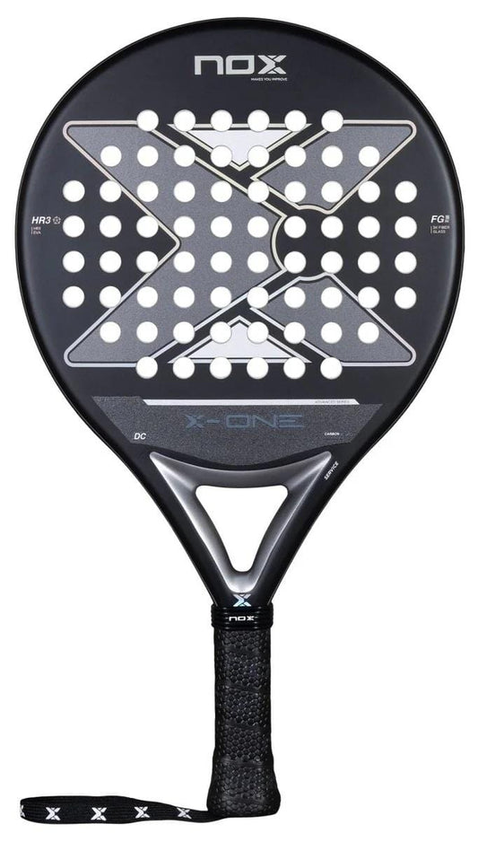 The NOX X-One Advance Series Padel Racket - Black features a large white "X" on its face, multiple circular holes, an HR3 rubber core, textured handle, and wrist strap. Brand: NOX.