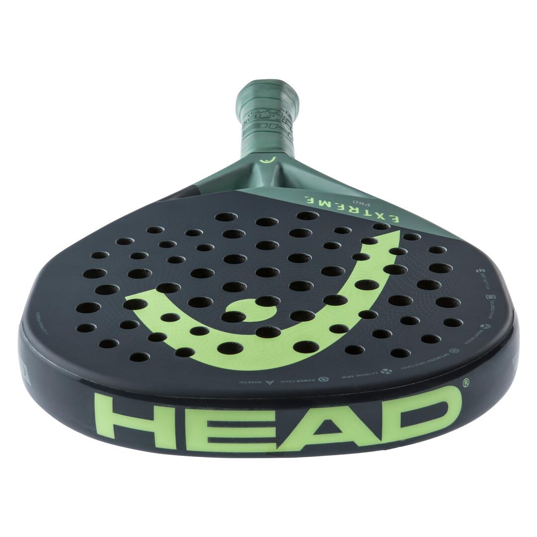 The HEAD Extreme Pro 2023 Padel Racket in green displays the word "HEAD" in bold green on the rim. It features a perforated surface with Auxetic technology and "EXTREME" printed on the neck, offering unparalleled performance.