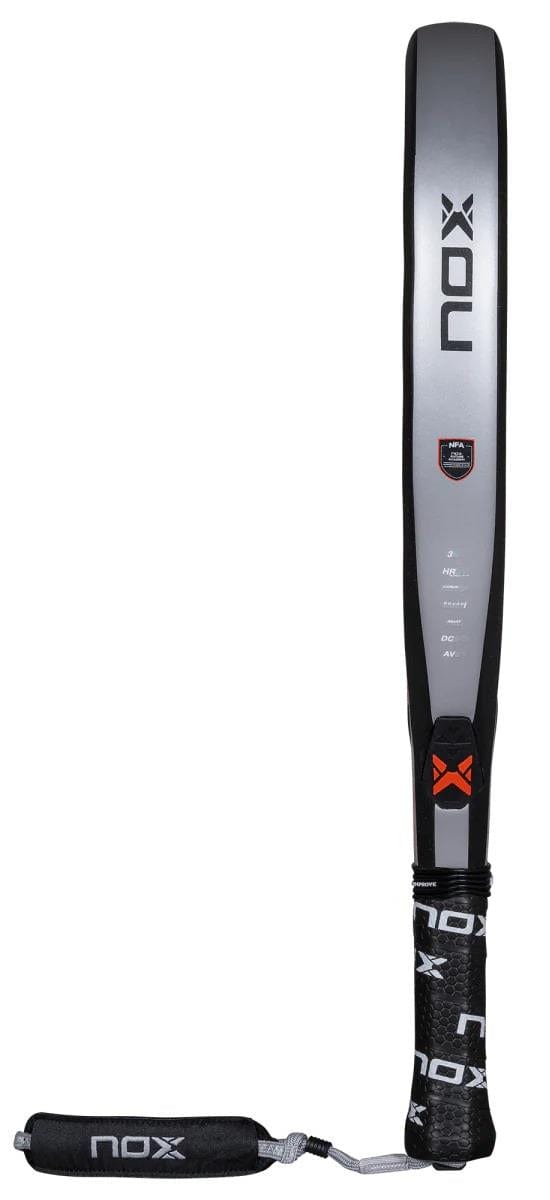 The NOX NFA Nextgen Pro Attack 3K Padel Racket in black and silver is shown vertically, displaying NOX branding on the face and handle, with a black wrist strap. Designed for precision and power.
