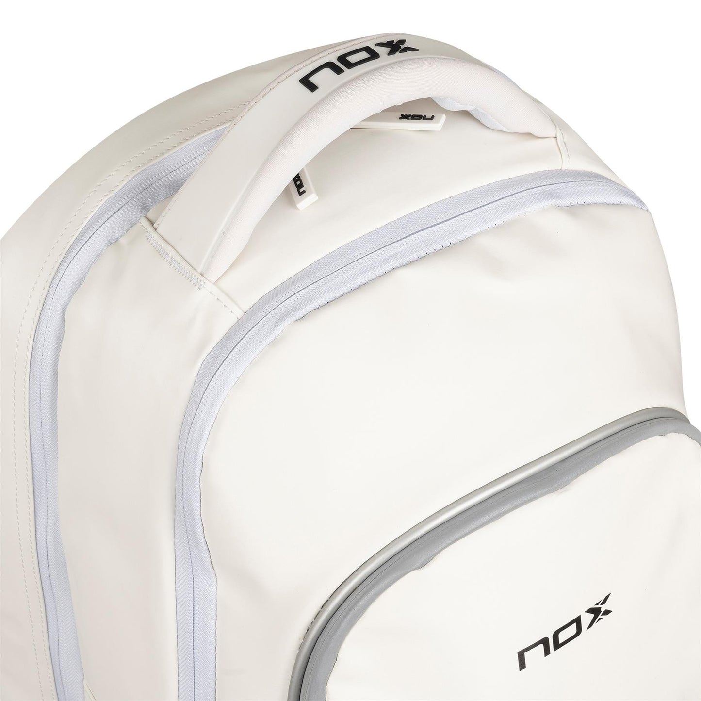 Close-up of the NOX Pro Series Padel Backpack - White by NOX, featuring light gray zippers and trim plus "nox" in black on the handle and front pocket—a stylish choice for padel players on the go.