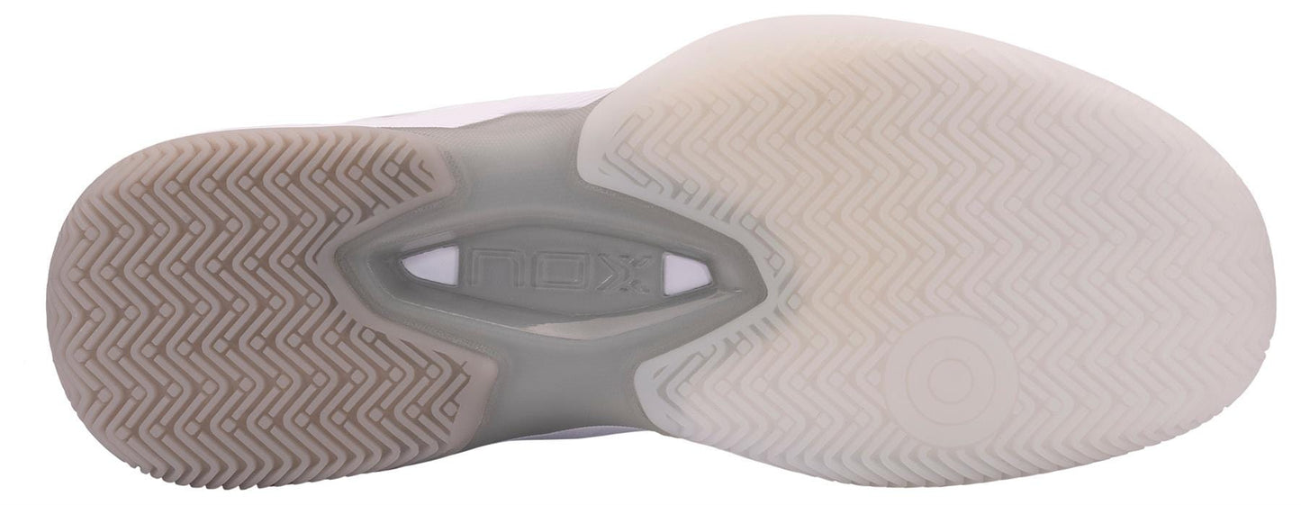 Close-up of the sole on NOX AT10 Lux Men's Padel Shoes - White/Grey, featuring a textured brown and translucent white zigzag tread with embossed NOX logo—Agustin Tapia's top pick for Best Power Padel Shoe.