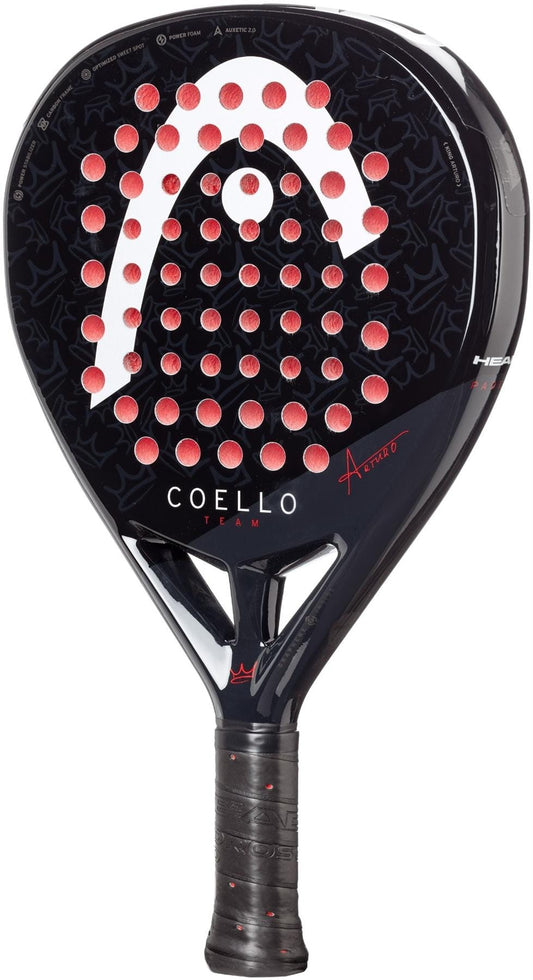 The HEAD Coello Team 2025 Padel Racket in black features red circular holes, “COELLO TEAM” on the face, Power Foam for power, a textured grip, Auxetic 2.0 technology, and subtle patterned details. Brand: HEAD.