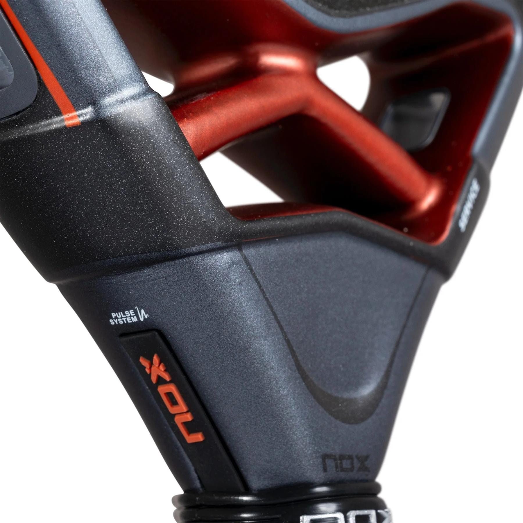 Close-up of the NOX AT10 Luxury Genius 18K Alum By Agustin Tapia 2025 padel racket, showcasing metallic red and black angular designs, "NOX" branding, "PULSE SYSTEM" label, and advanced 18K Carbon Alum construction.