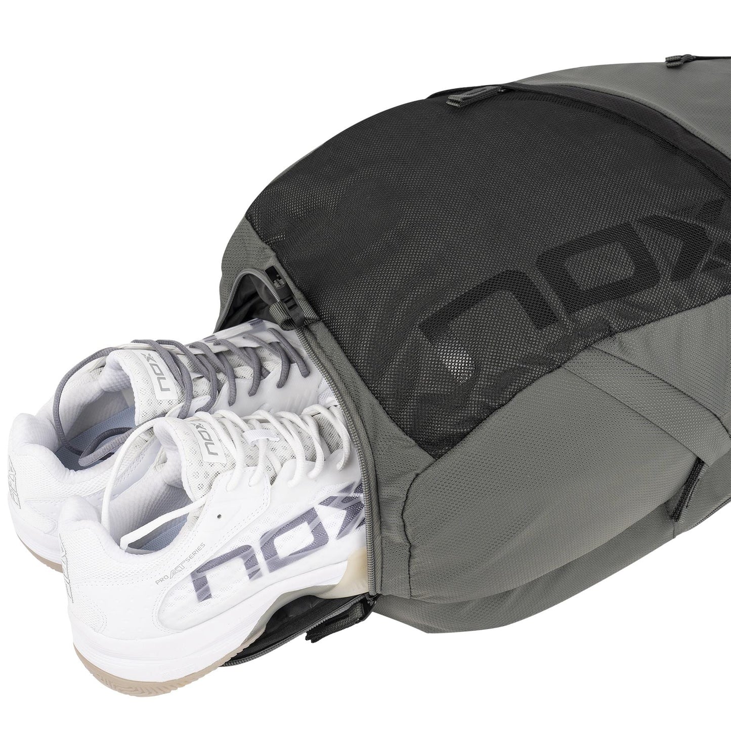 A pair of white NOX sneakers peeks from the NOX Street Series Padel Backpack - Grey, featuring ergonomic padded straps and a mesh zippered compartment. The visible NOX logo on both makes it ideal for your sports adventures.