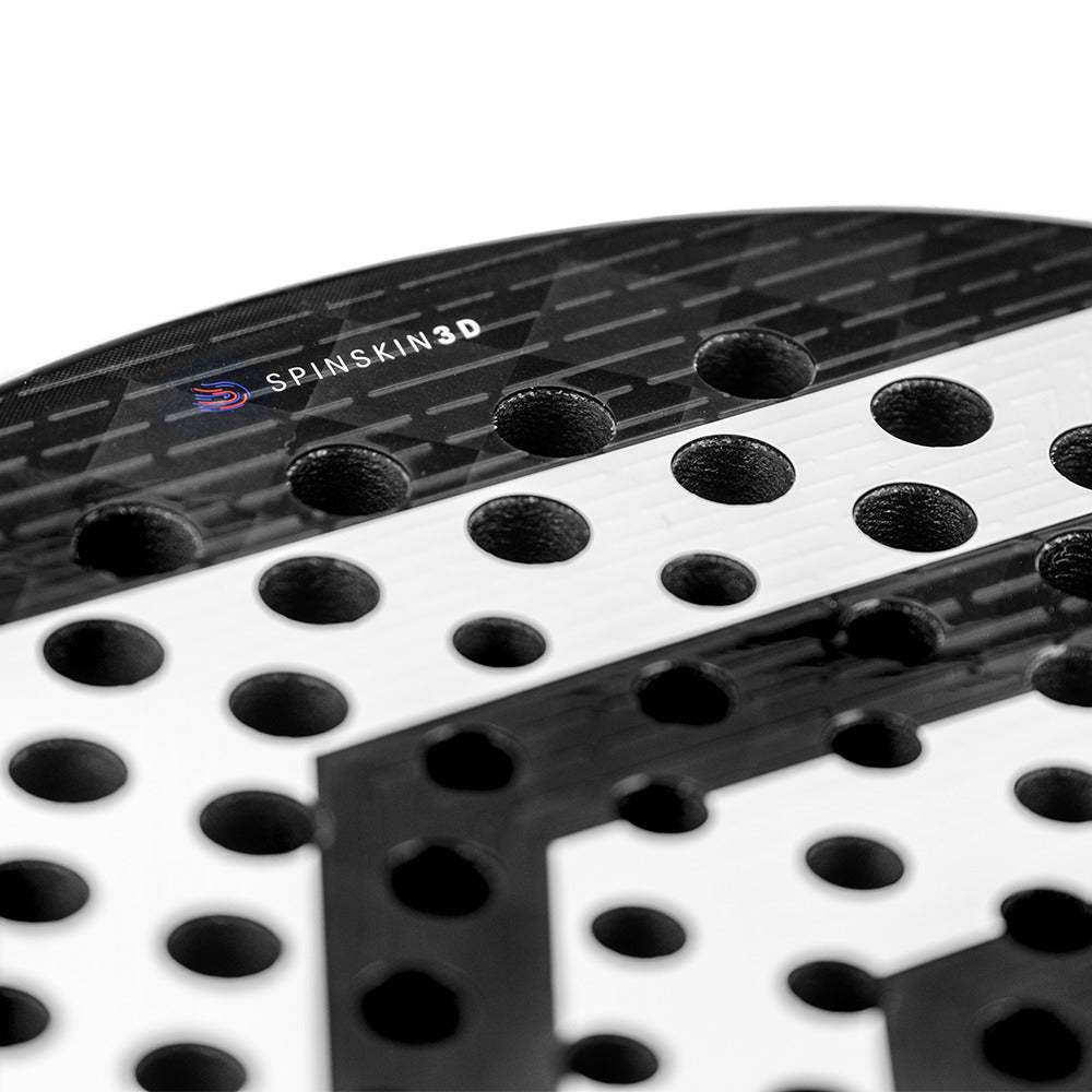 Close-up of the Tecnifibre Curva Power Padel Racket - Black, showcasing circular holes and an 18K carbon face with a textured look featuring "SPINSKIN3D" branding.