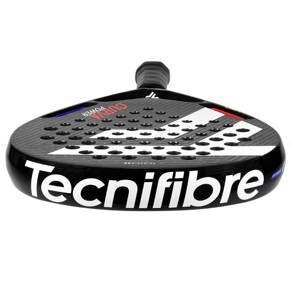 A close-up of the Tecnifibre Curva Power Padel Racket - Black shows "Tecnifibre" on its bottom edge. The 18K carbon face features circular holes, and the handle is expertly wrapped for grip.
