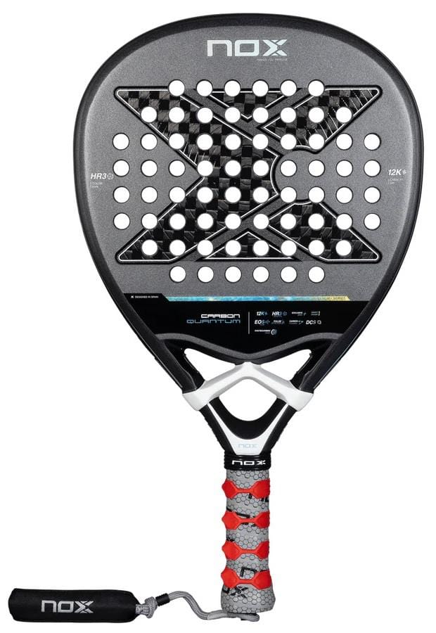 The NOX Luxury Quantum 12K Carbon 2025 padel racket in black/grey features a large “X” face design, perforated holes, a red and grey textured grip, detachable black wrist strap, and EXCLUSIVE SPIN tech for superior performance.