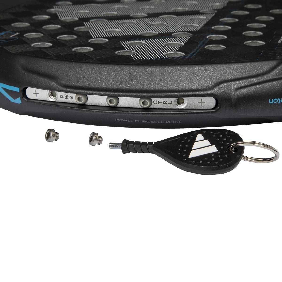 A close-up of the ADIDAS Adipower Multiweight CTRL 3.4 Padel Racket head shows screw holes with two screws and a keychain tool nearby. The racket edge, favored by Álex Ruiz, has a textured black surface with small circular cutouts.