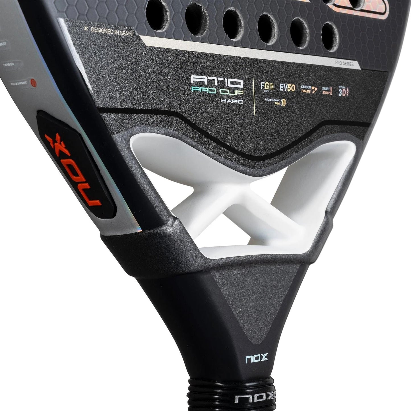Close-up of the NOX AT10 Pro Cup HARD By Agustin Tapia 2025 padel racket, showing a black design, Smartstrap, white bridge supports, branding details, and textured surface.