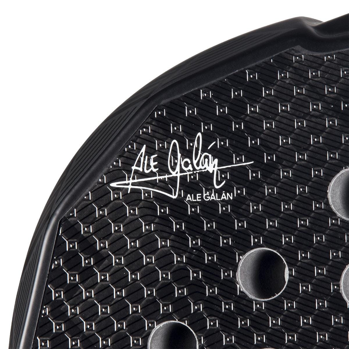 Close-up of the adidas Metalbone 3.4 Padel Racket - Black/White designed for advanced players, featuring a textured surface with hexagonal patterns and circular holes. The "Ale Galán" signature is prominently displayed, adding finesse to this precision-engineered masterpiece.