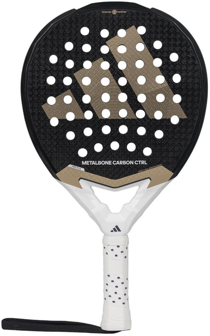 The ADIDAS Metalbone Carbon CTRL 3.4 padel racket for advanced players features a perforated black surface with a gold geometric logo, a white handle with black polka dots, and includes a wrist strap.